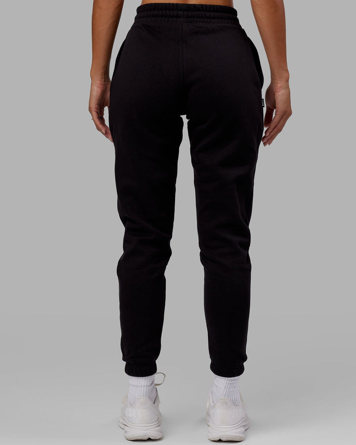 Woman wearing Unisex Capsule Track Pant - Black