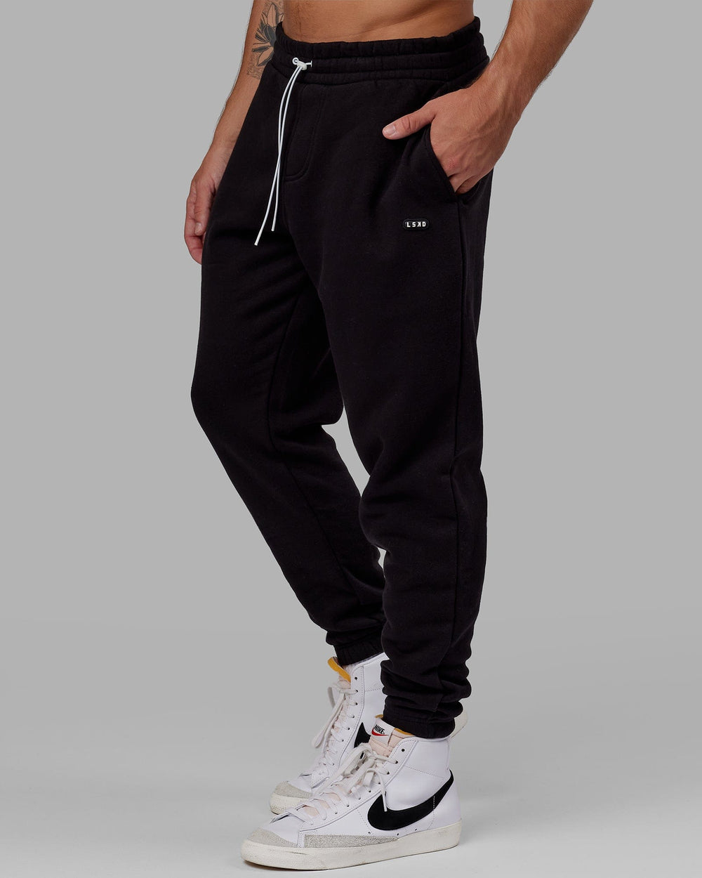 Man wearing Unisex Capsule Track Pant - Black