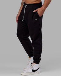 Man wearing Unisex Capsule Track Pant - Black