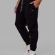 Man wearing Unisex Capsule Track Pant - Black