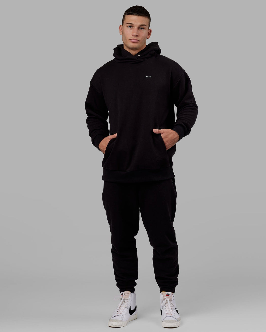 Man wearing Unisex Capsule Track Pant - Black