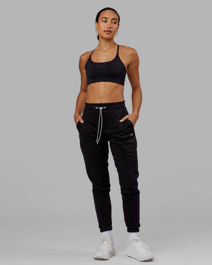 Woman wearing Unisex Capsule Track Pant - Black