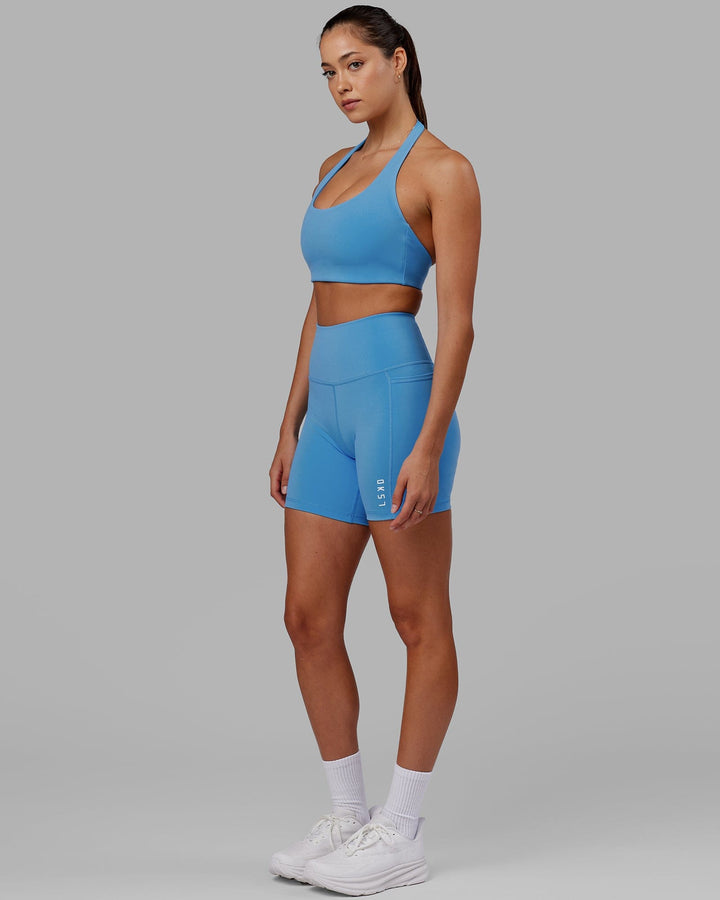 Woman wearing Challenger Sports Bra - Azure Blue