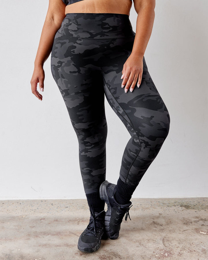 Woman wearing Elixir Full Length Tight - Black Camo
