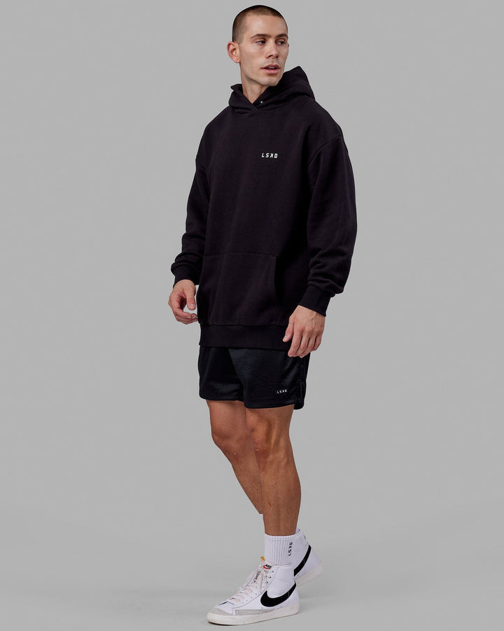 Man wearing Endeavour Longline Hoodie Oversize - Black