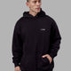 Man wearing Endeavour Longline Hoodie Oversize - Black