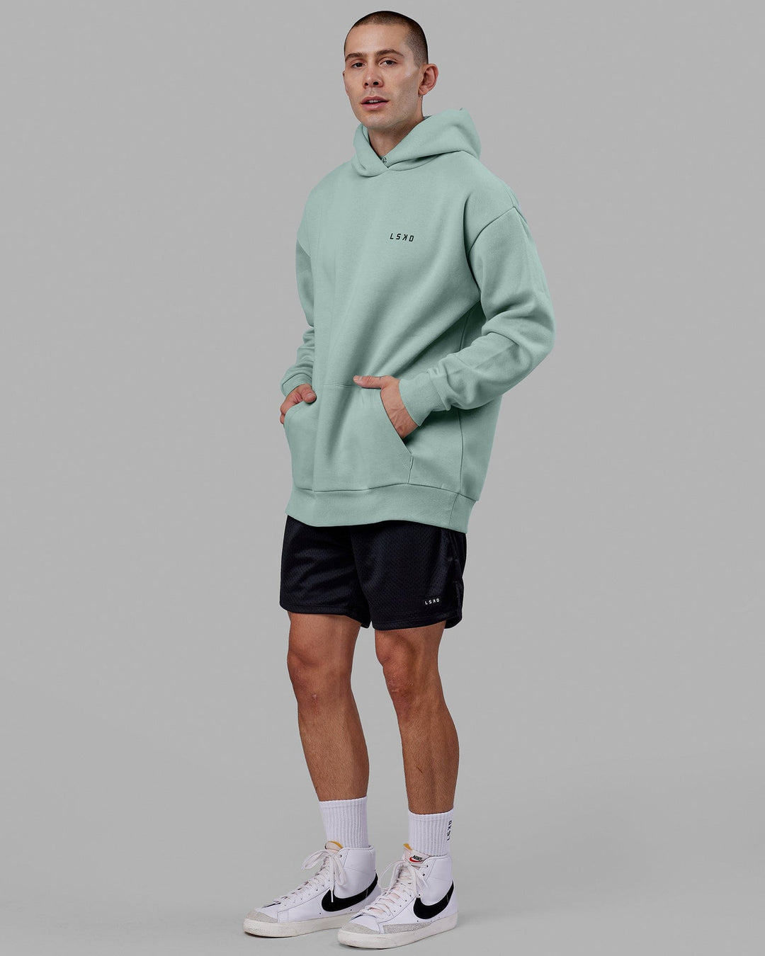 Man wearing Endeavour Longline Hoodie Oversize - Pastel Turquoise