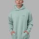 Man wearing Endeavour Longline Hoodie Oversize - Pastel Turquoise