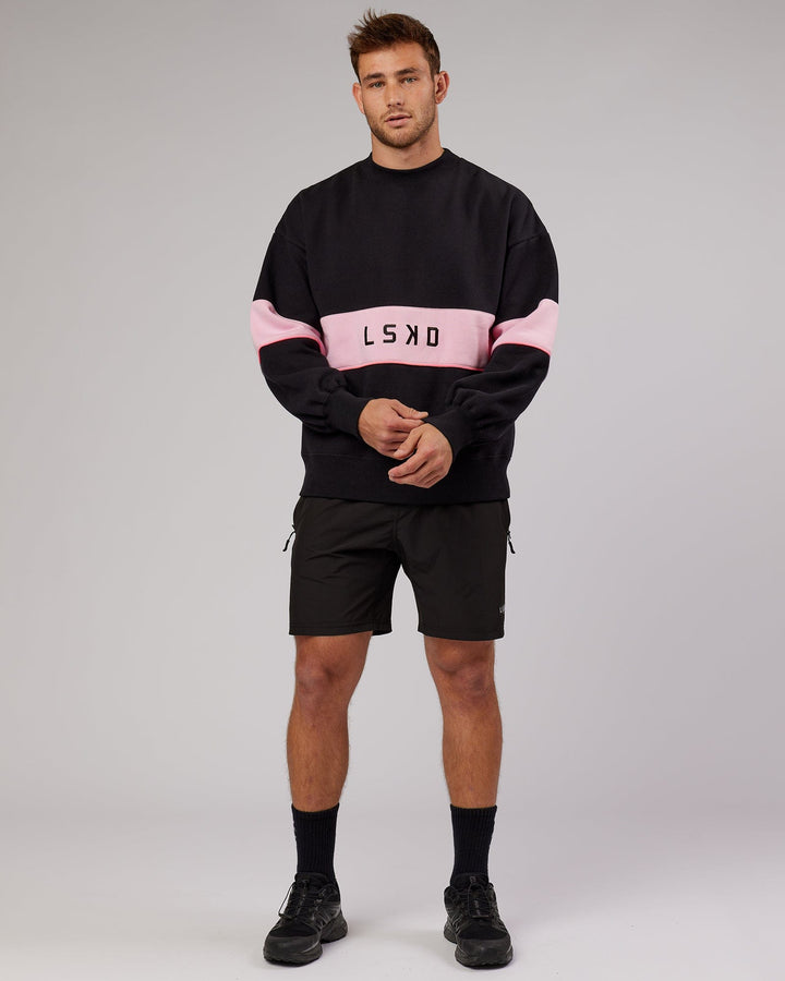 Man wearing Unisex Extra Time Sweater Oversize - Black-Petal Pink
