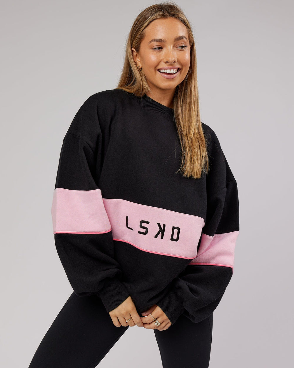 Woman wearing Unisex Extra Time Sweater Oversize - Black-Petal Pink