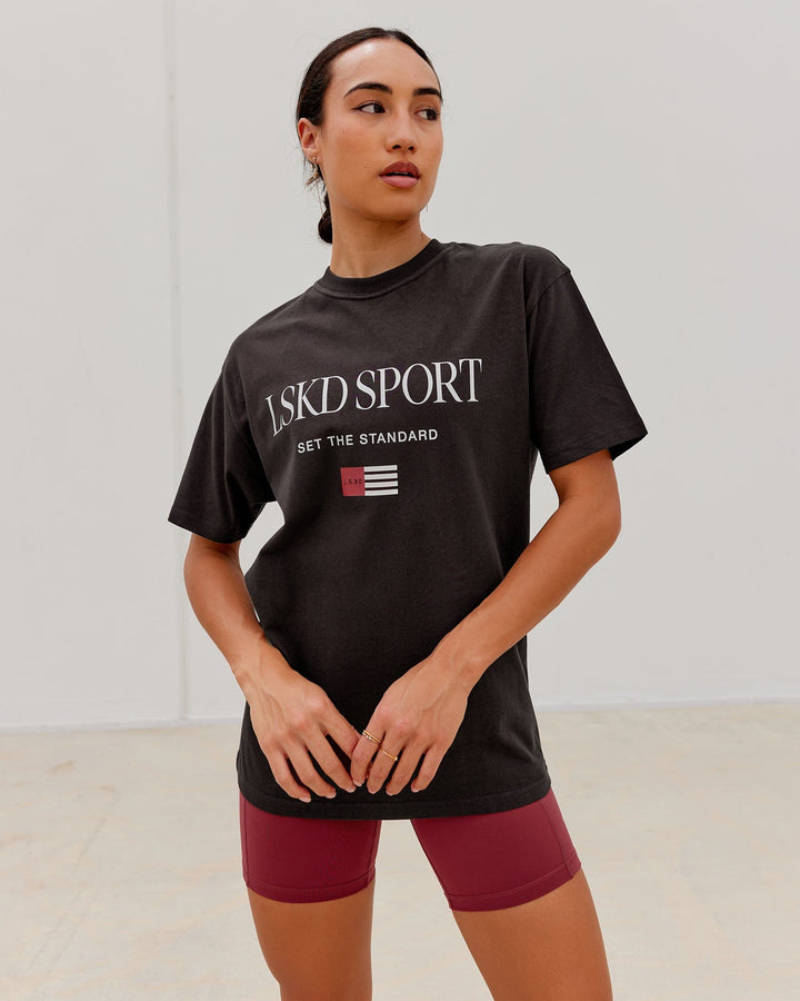 Woman wearing Unisex Flag Heavyweight Tee Oversize - Dark Walnut