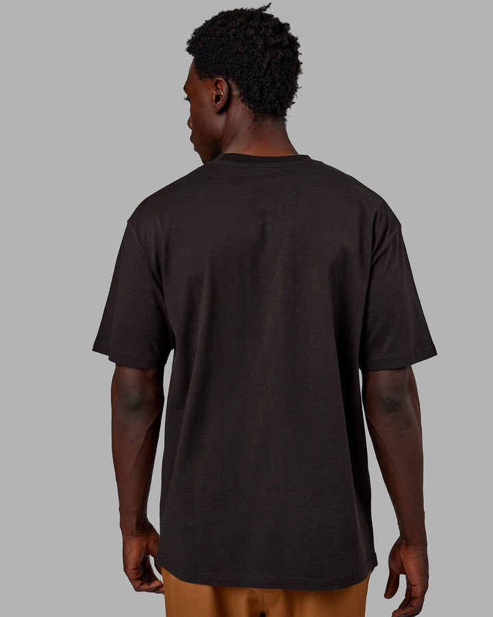 Man wearing Unisex Flag Heavyweight Tee Oversize - Dark Walnut