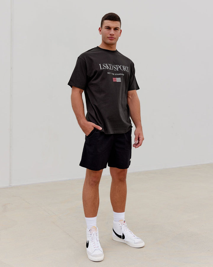 Man wearing Unisex Flag Heavyweight Tee Oversize - Dark Walnut