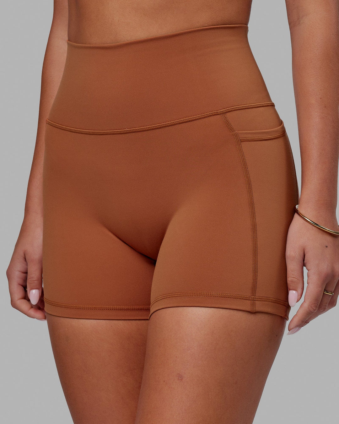 Woman wearing Fusion Ultra High-Rise 4" Short Pockets - Hazel | Model:Milly | Size:S