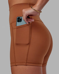 Woman wearing Fusion Ultra High-Rise 4" Short Pockets - Hazel | Model:Milly | Size:S