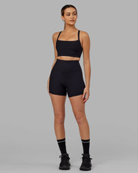 Woman Wearing Momentum Ribbed Sports Bra - Black
