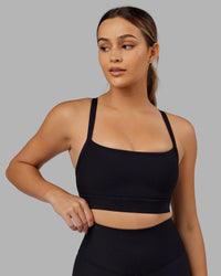 Woman Wearing Momentum Ribbed Sports Bra - Black