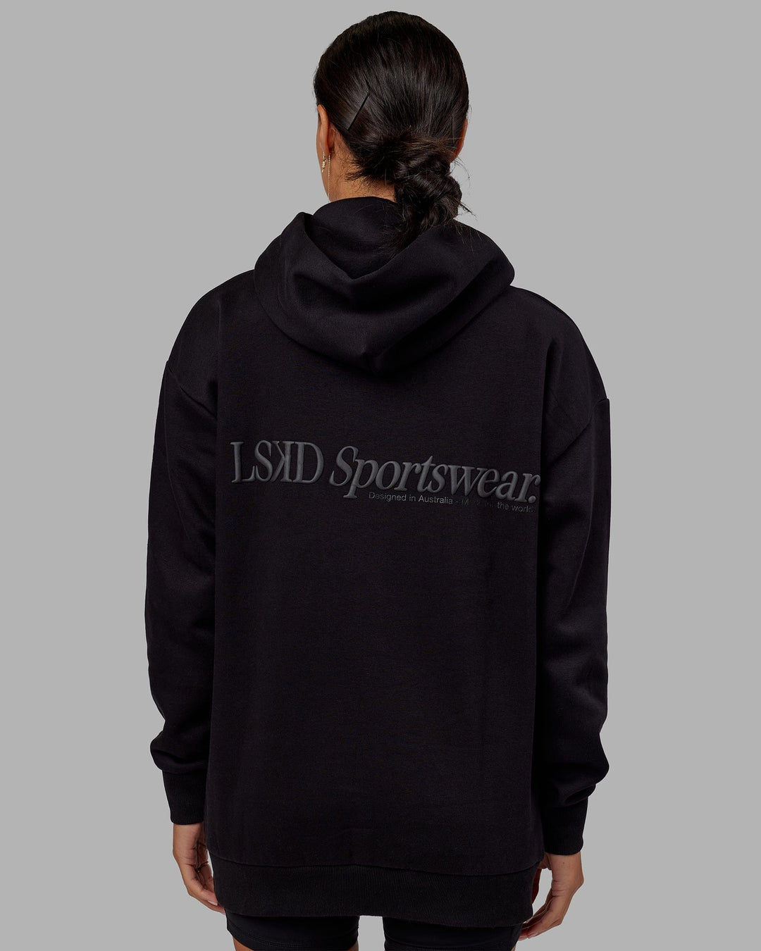 Woman wearing Unisex Motion Hoodie Oversize - Black-Black
