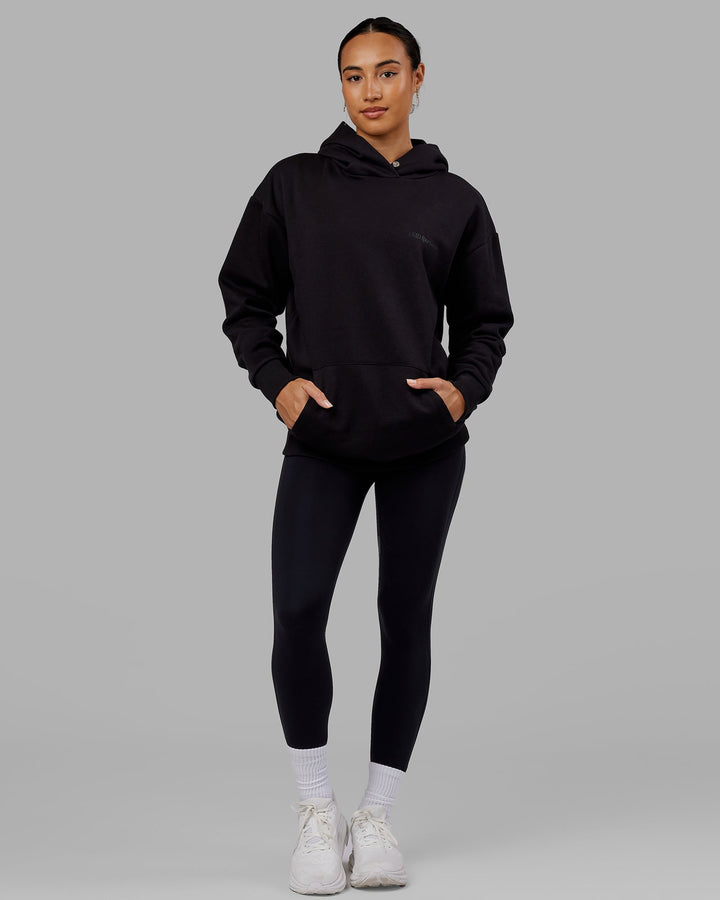 Woman wearing Unisex Motion Hoodie Oversize - Black-Black