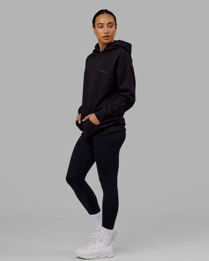 Woman wearing Unisex Motion Hoodie Oversize - Black-Black