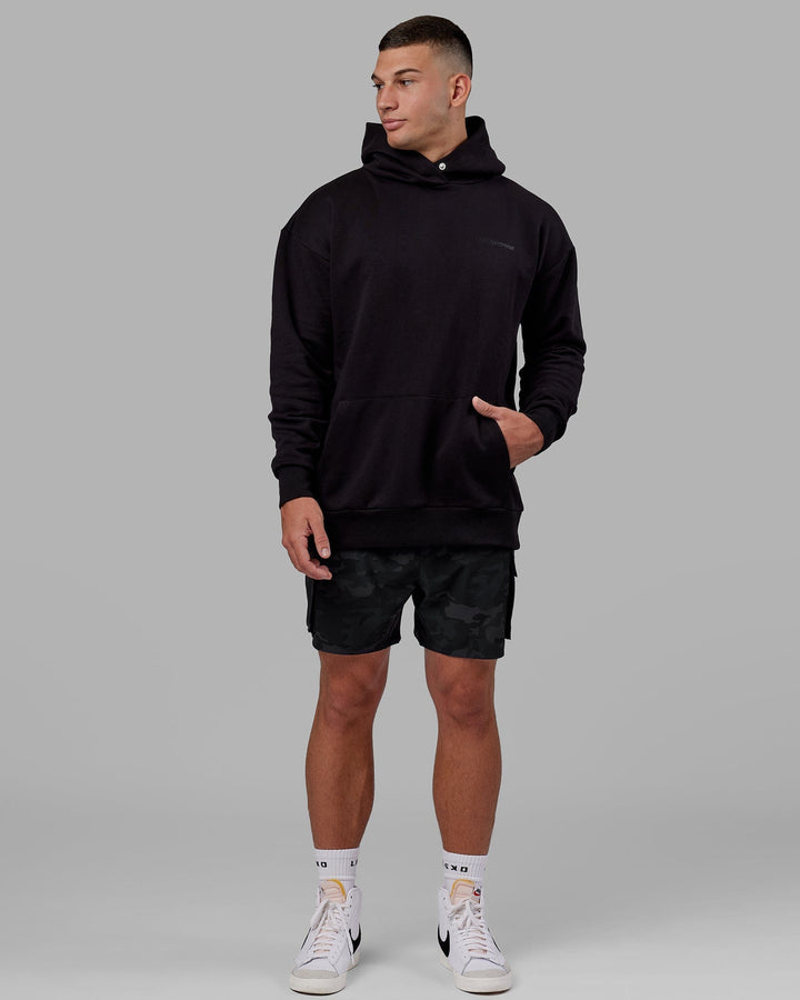 Man wearing Unisex Motion Hoodie Oversize - Black-Black