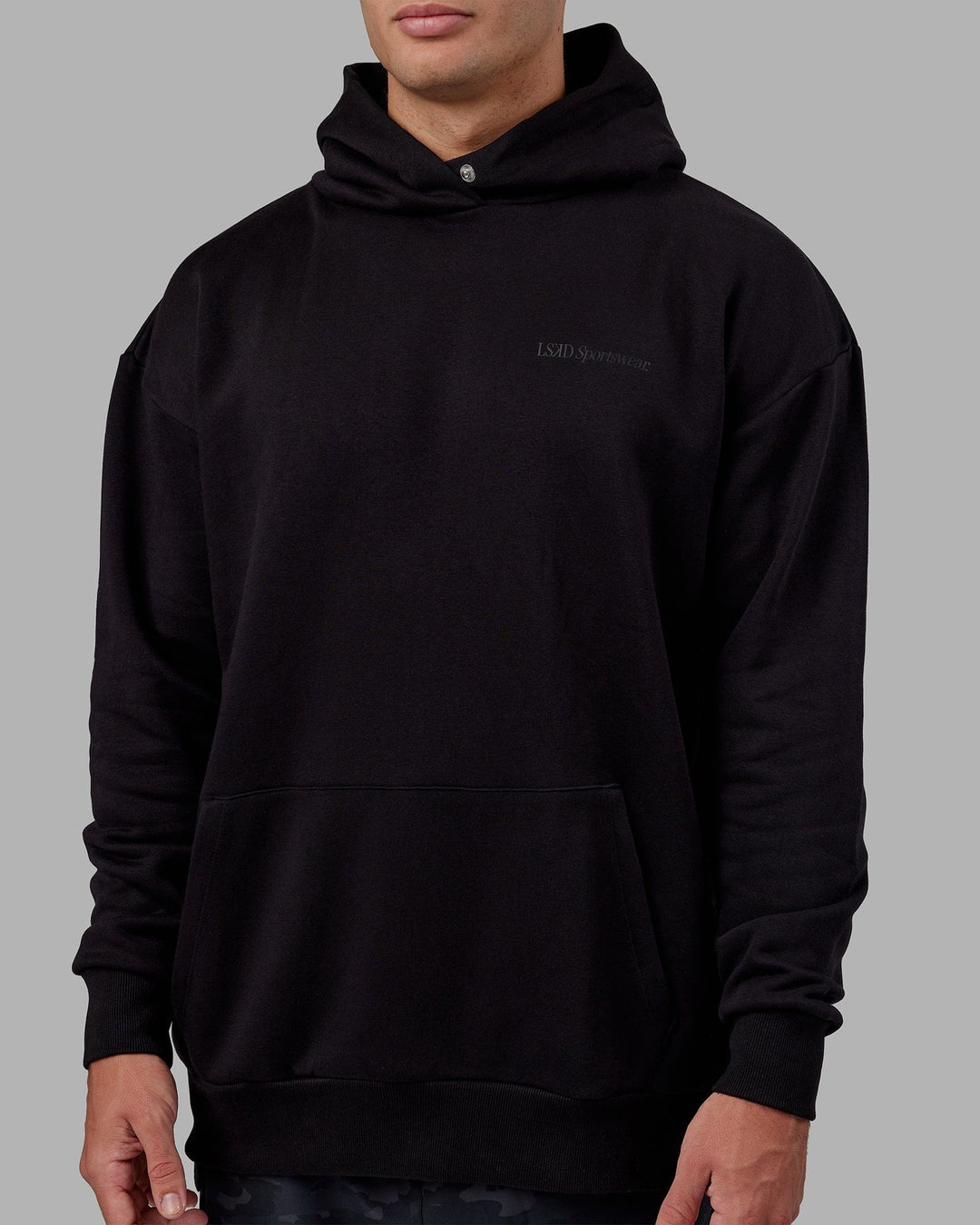 Man wearing Unisex Motion Hoodie Oversize - Black-Black