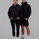 Man and Woman wearing Unisex Motion Hoodie Oversize - Black-Black