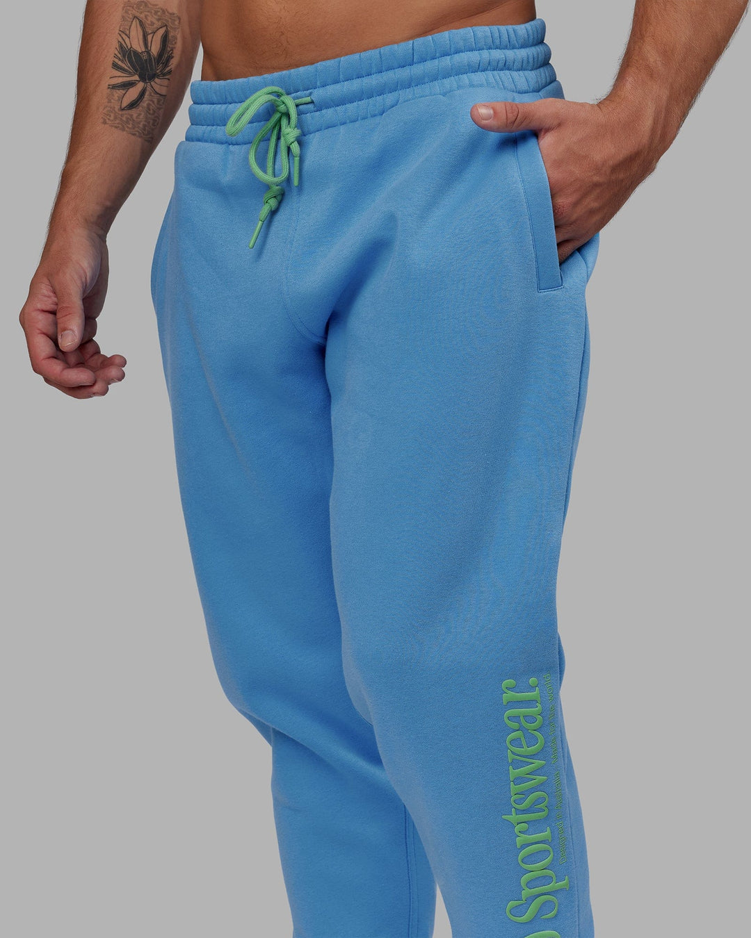Man wearing Unisex Motion Trackpant - Azure Blue