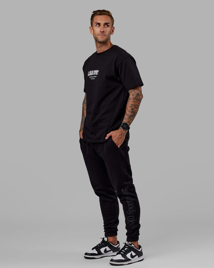 Man wearing Unisex Motion Trackpant - Black-Black