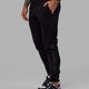 Man wearing Unisex Motion Trackpant - Black-Black