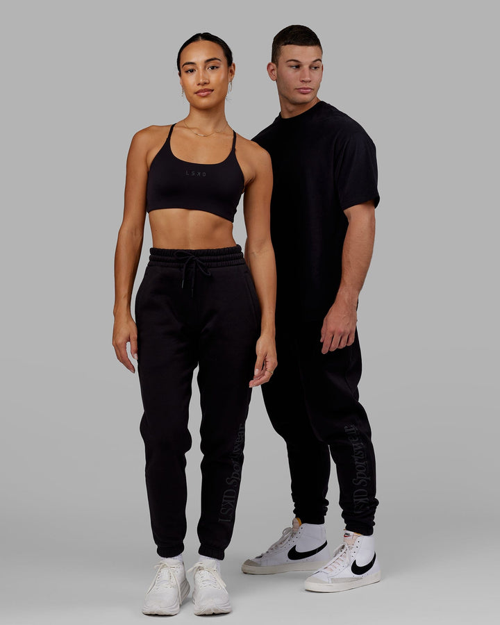 Man and Woman wearing Unisex Motion Trackpant - Black-Black