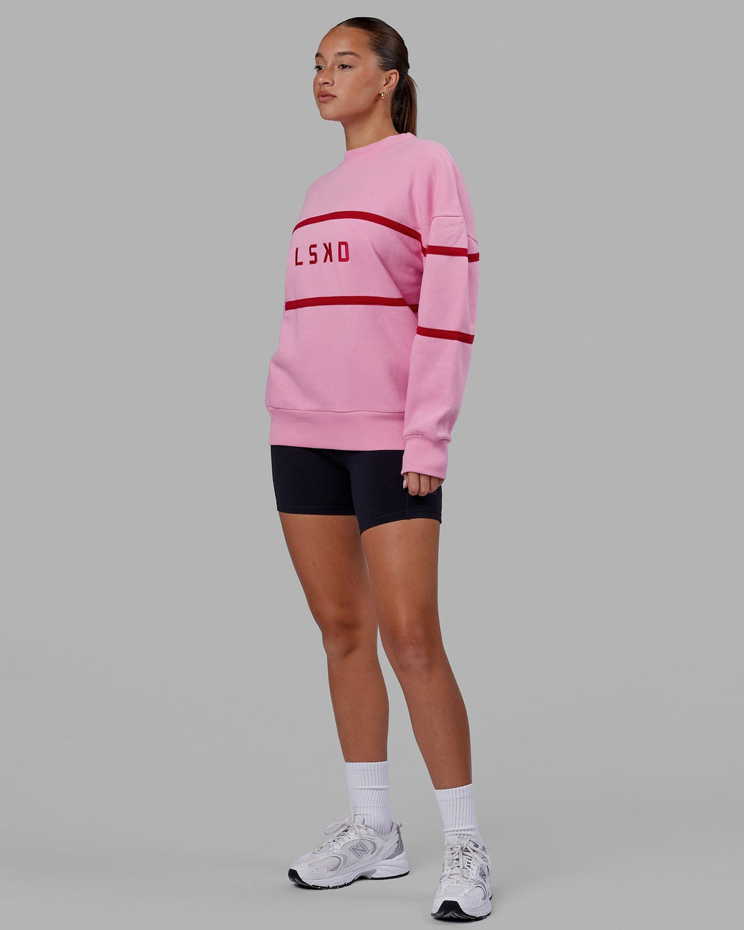 Woman wearing Unisex Parallel Sweater Oversize - Pink Frosting
