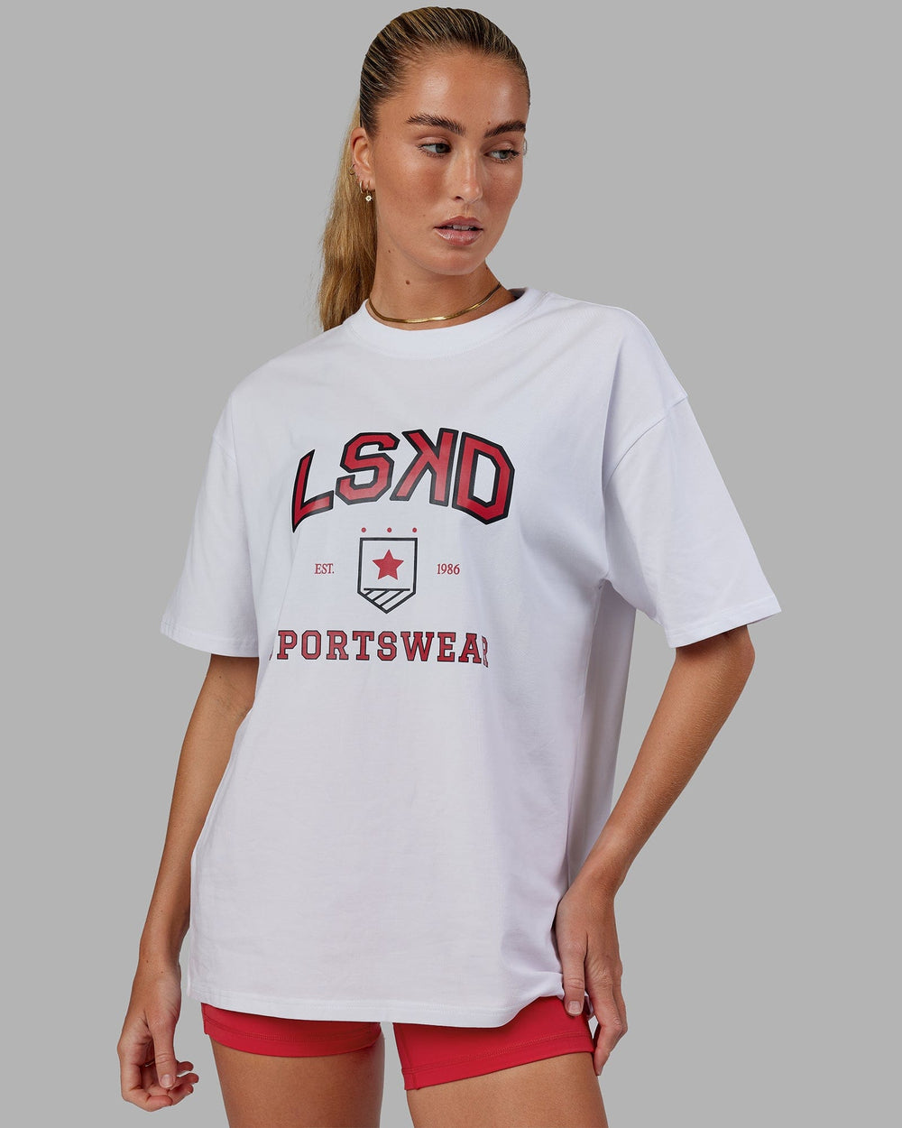 Woman wearing Unisex Sports Dept. Tee Oversize - White-Red
