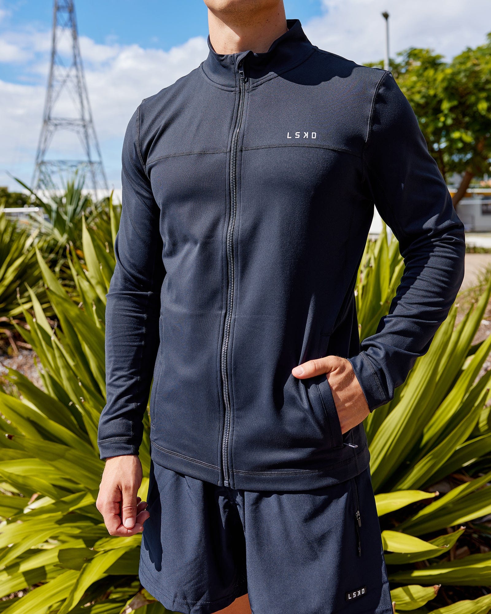 Man wearing Stride Zip Through Performance Jacket - Navy