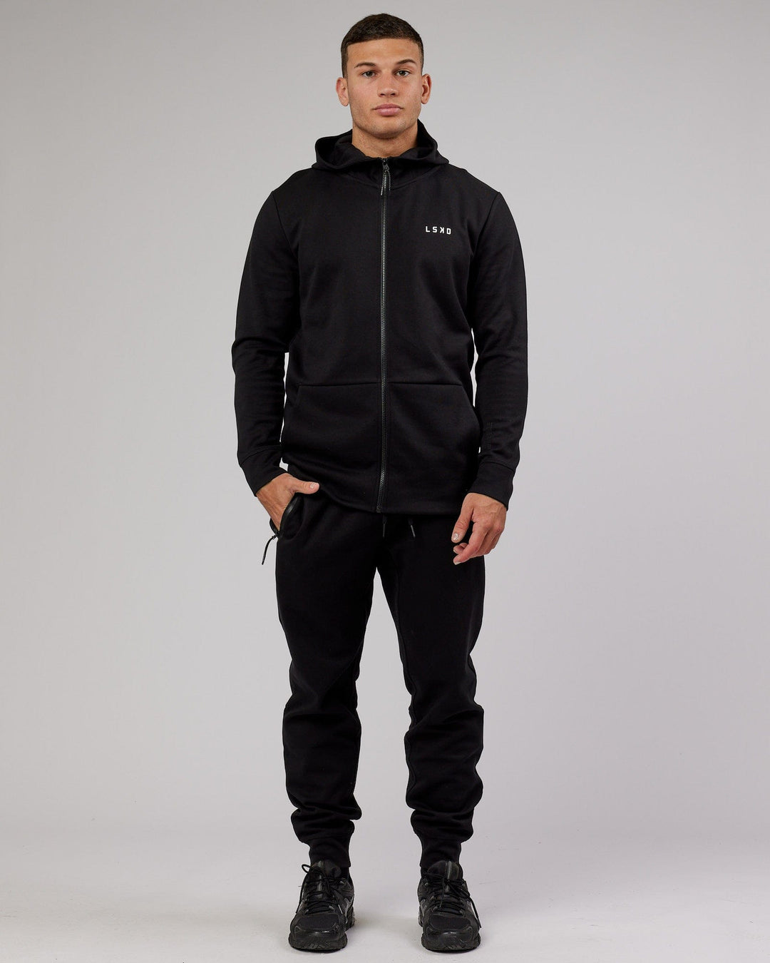 Man wearing Athlete ForgedFleece Zip Trackpant - Black