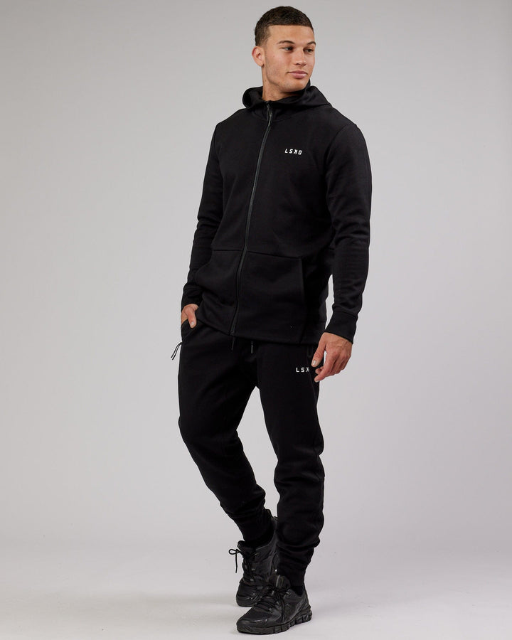 Man wearing Athlete ForgedFleece Zip Trackpant - Black