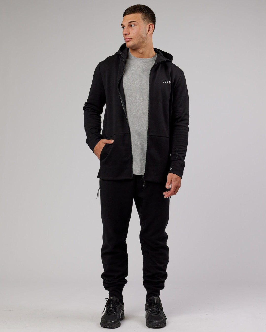 Man wearing Athlete ForgedFleece Zip Trackpant - Black