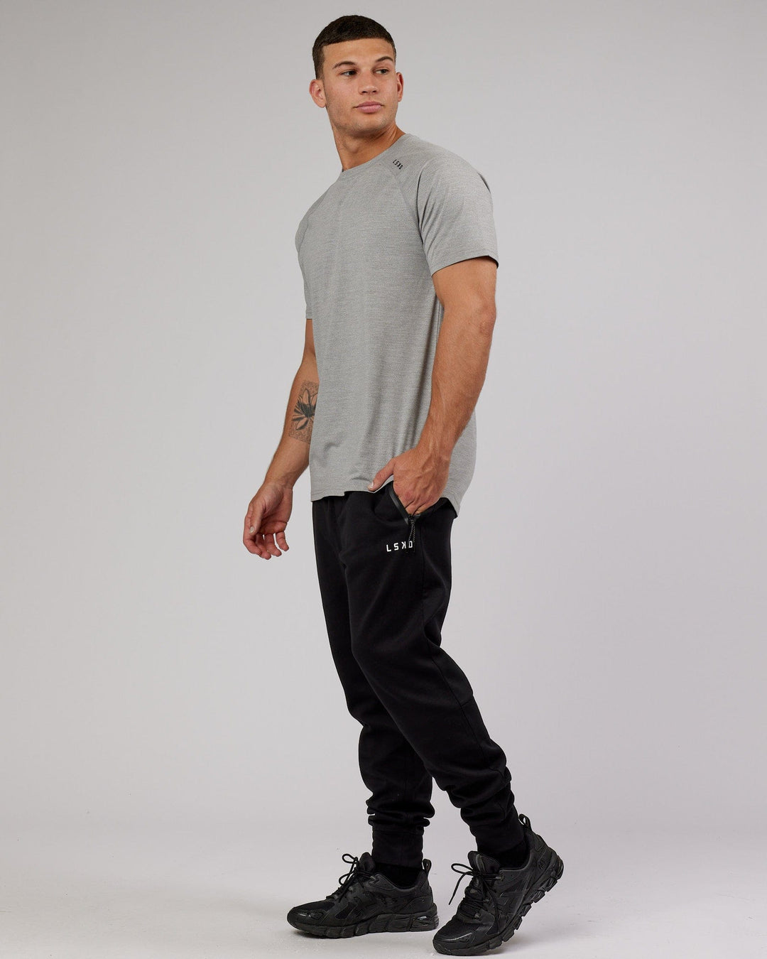 Man wearing Athlete ForgedFleece Zip Trackpant - Black