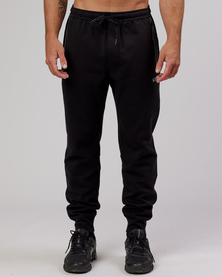 Man wearing Athlete ForgedFleece Zip Trackpant - Black