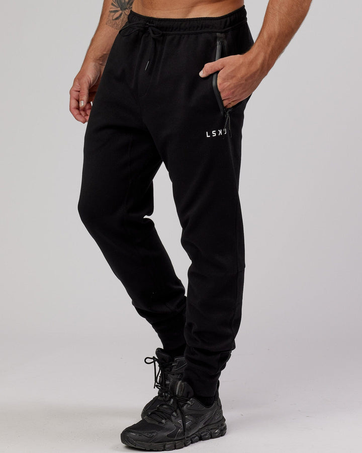 Man wearing Athlete ForgedFleece Zip Trackpant - Black