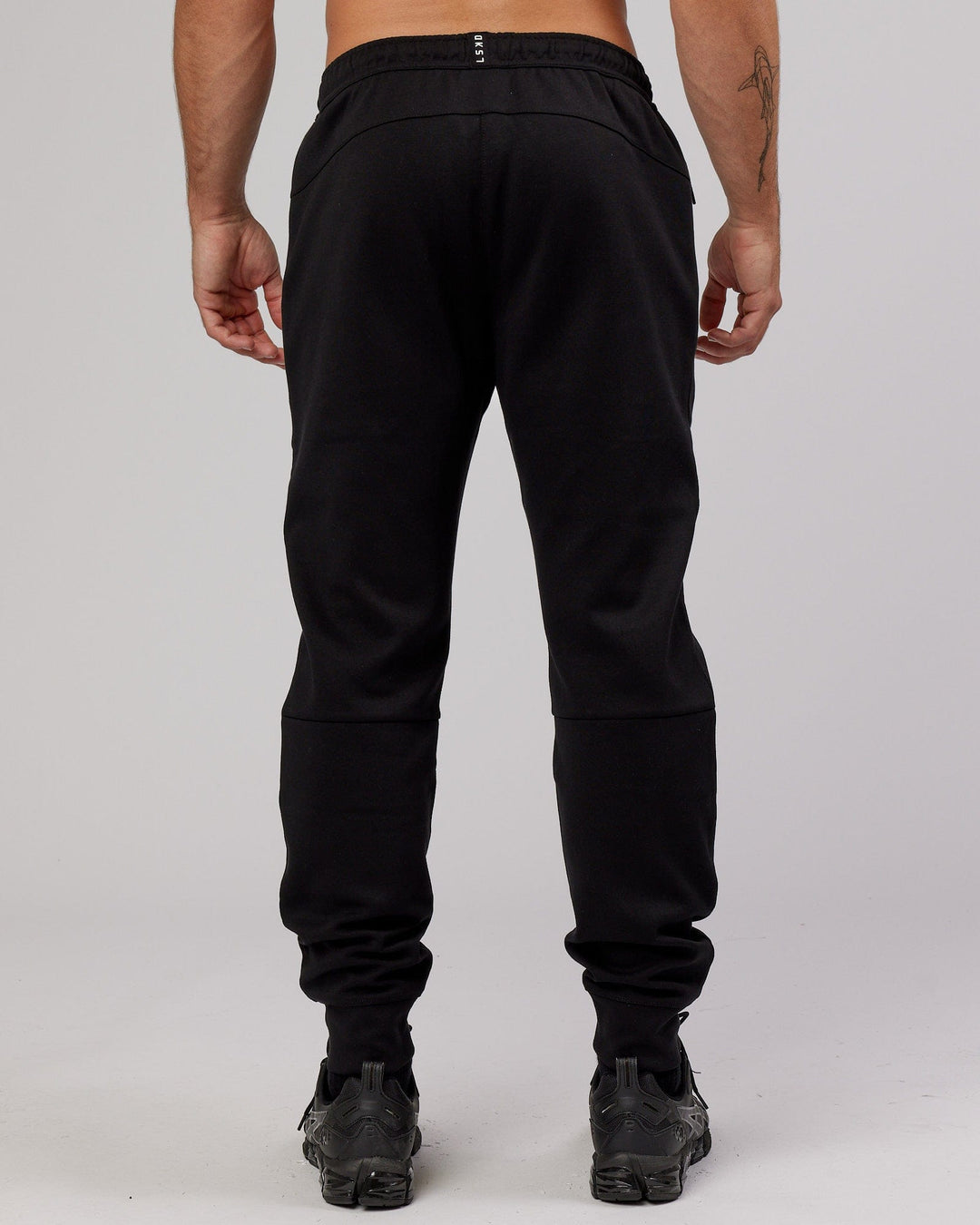 Man wearing Athlete ForgedFleece Zip Trackpant - Black