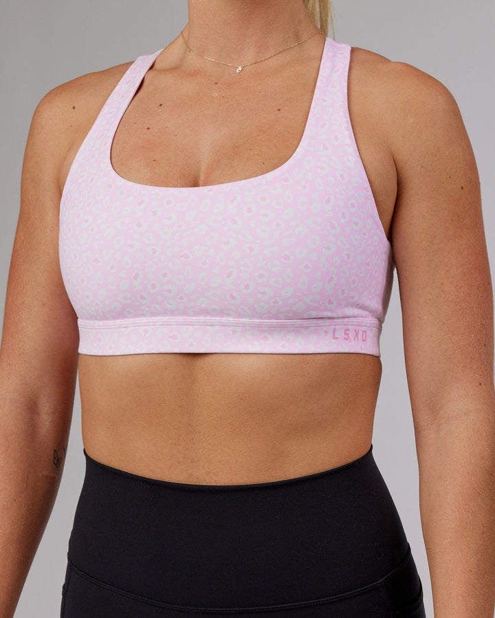 Woman wearing Base Sports Bra - Blush Leopard