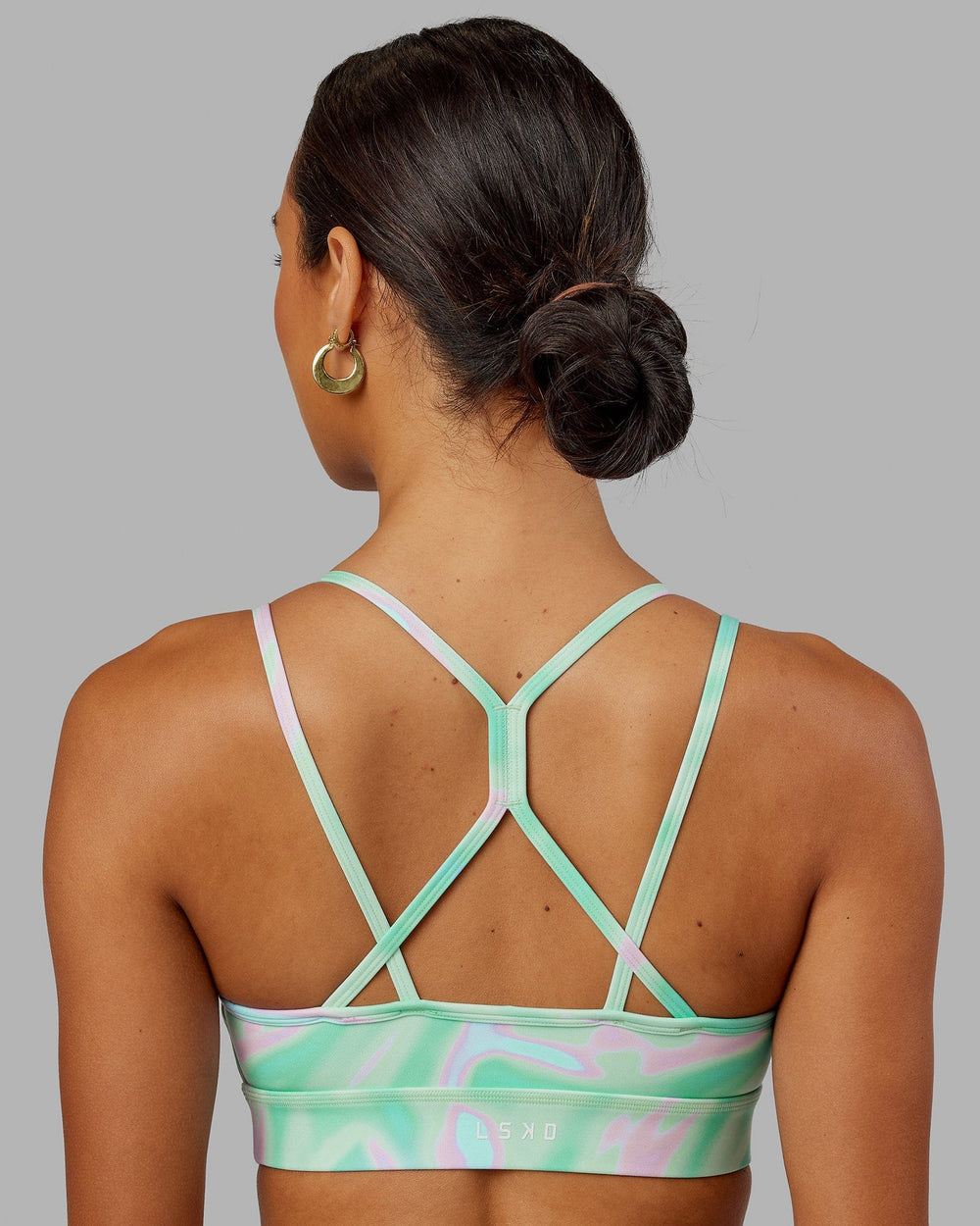 Woman wearing Bridge Sports Bra - Euphoria Teal