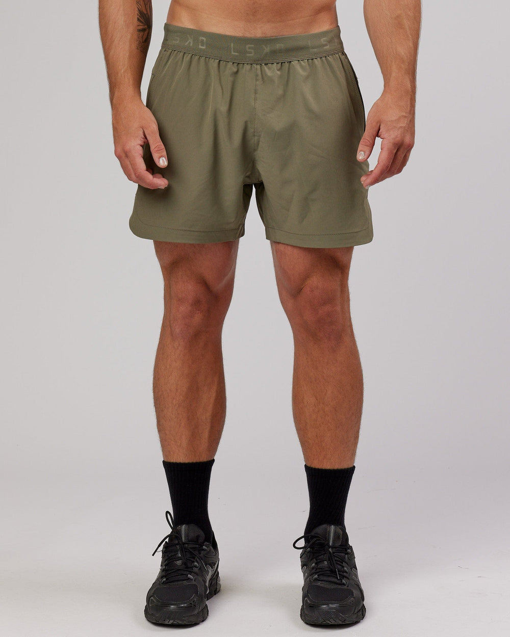 Man wearing Competition 5" Performance Short - Olive Fade
