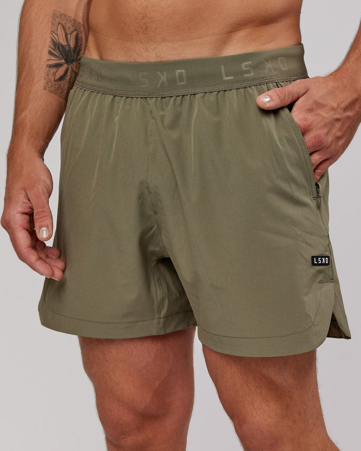 Man wearing Competition 5" Performance Short - Olive Fade
