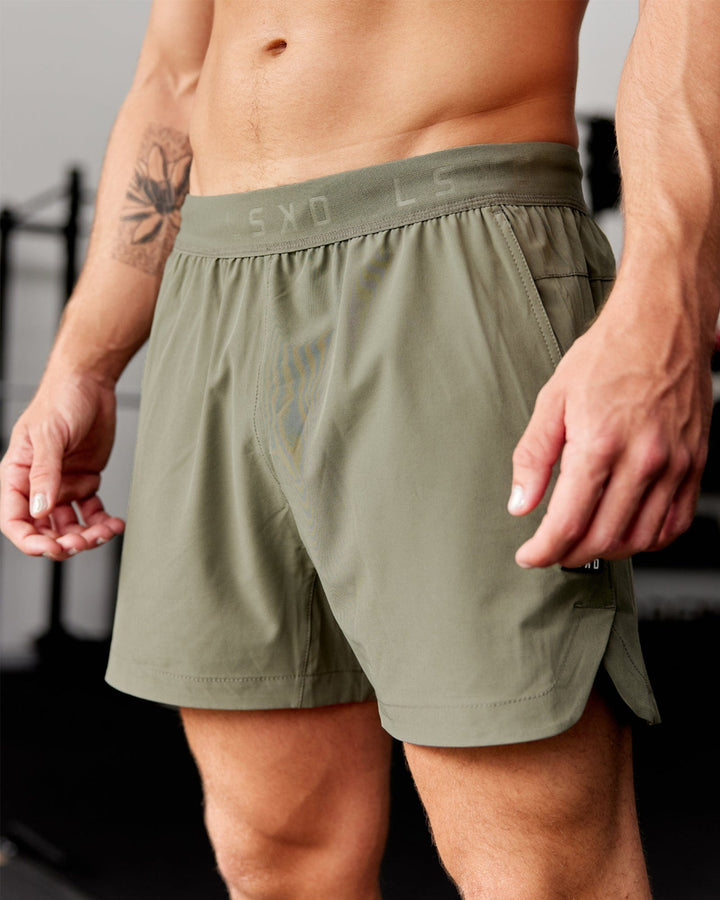Man wearing Competition 5" Performance Short - Olive Fade