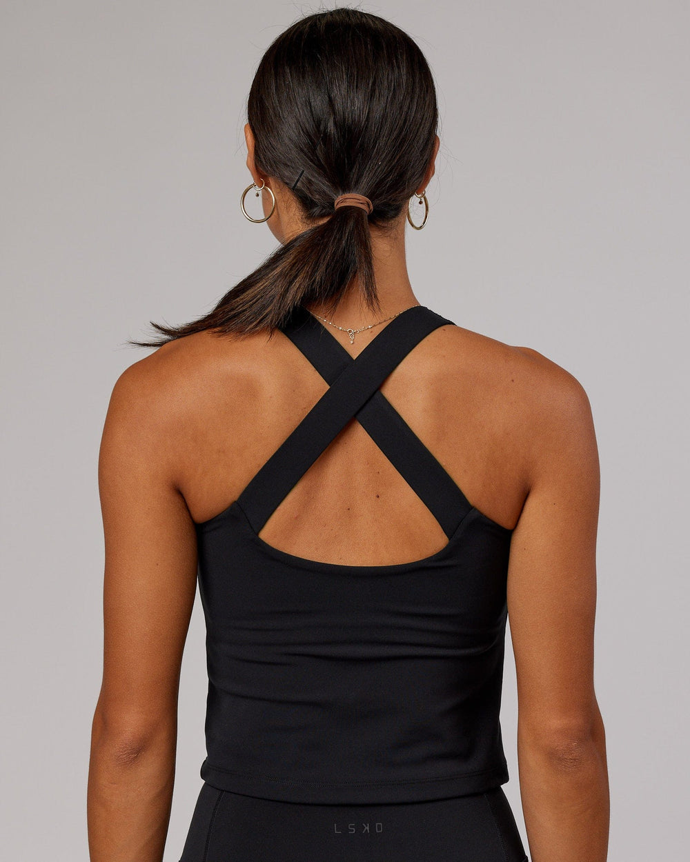 Woman wearing Driven Shelf Bra Performance Tank - Black