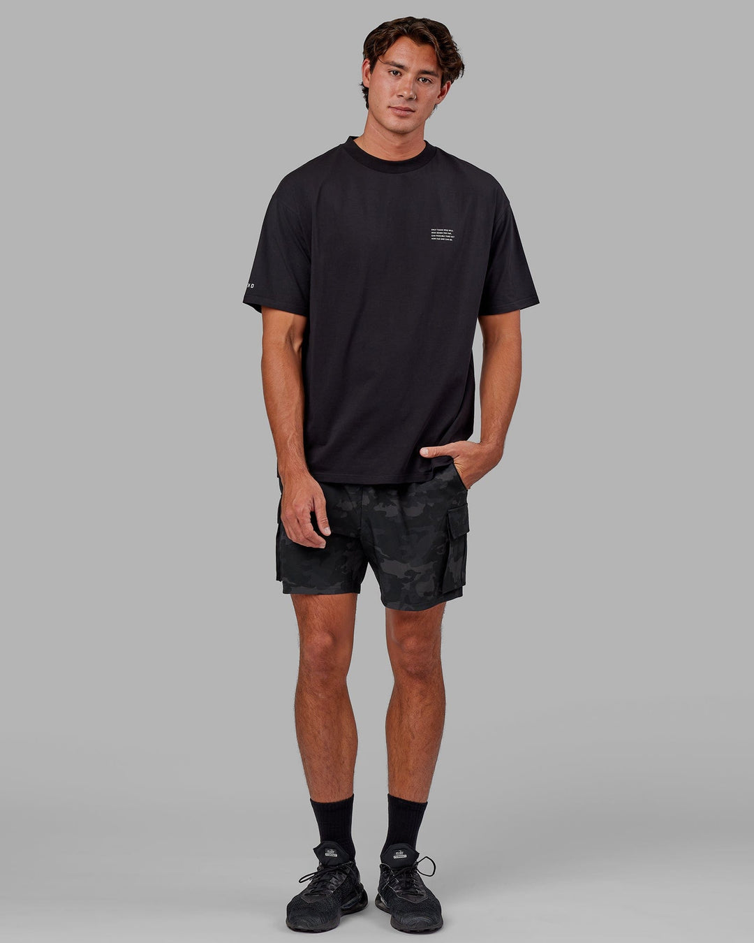 Man wearing Energy Stretch Performance Cargo Short - Black Camo