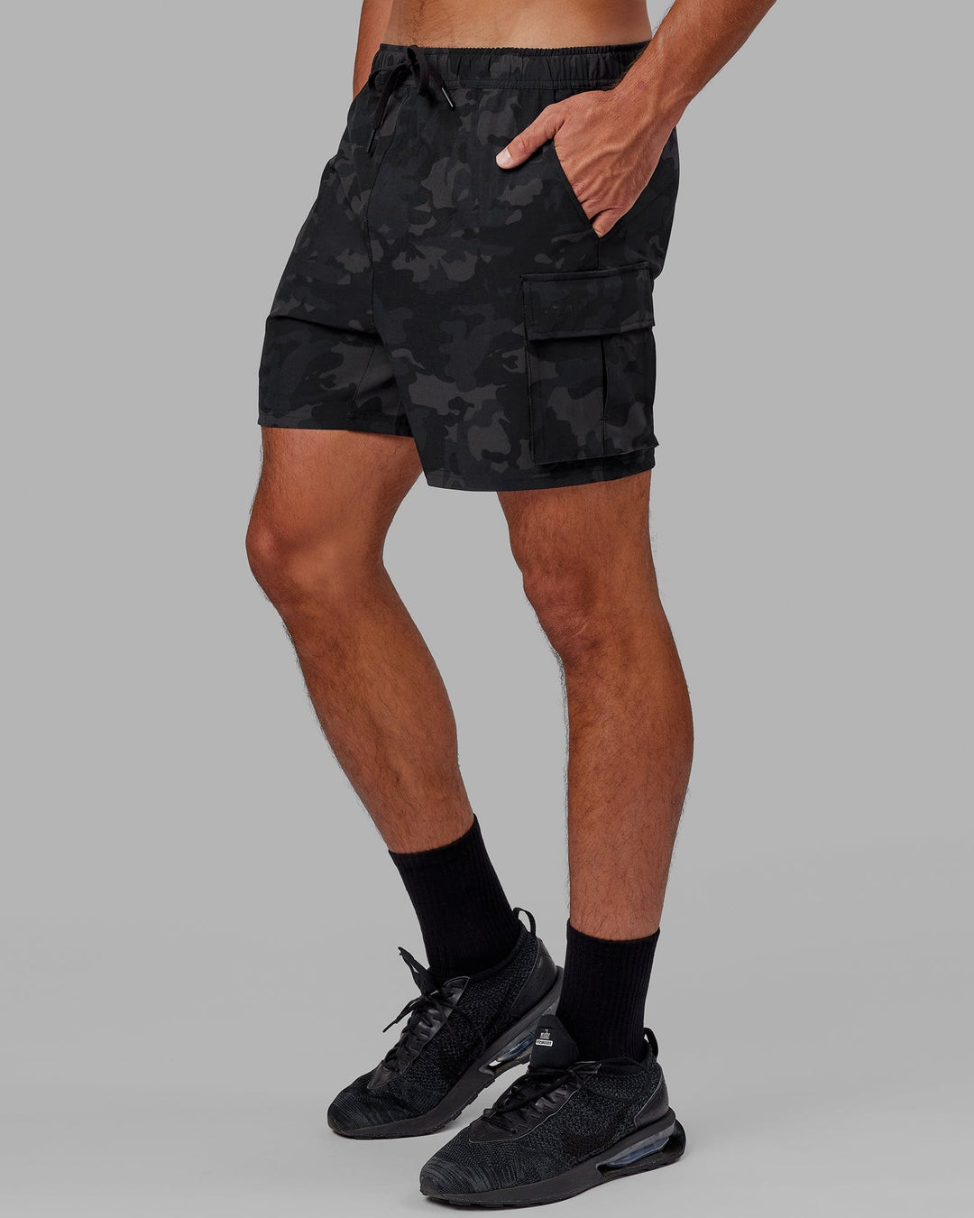 Man wearing Energy Stretch Performance Cargo Short - Black Camo