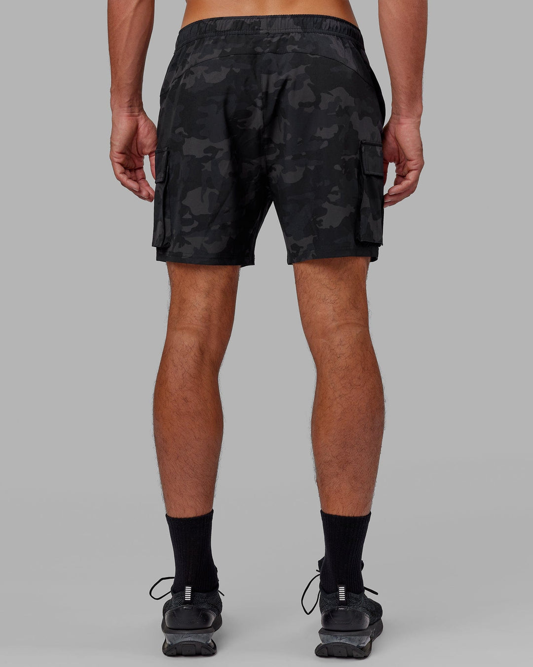 Man wearing Energy Stretch Performance Cargo Short - Black Camo